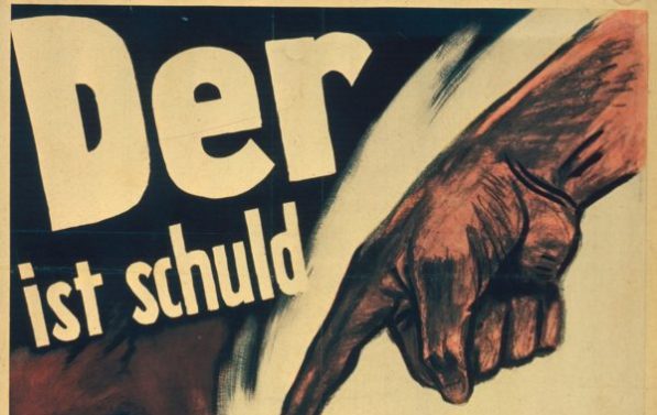 Nazistisk propaganda. En hånd som peker på en mann med hatt og davidsstjerne. På bilde står det "Der ist schuld am Kriege!"