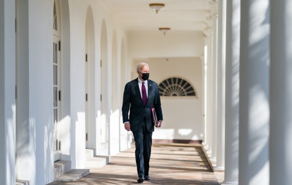 Biden går gjennom balustraden i Det hvite hus med mapper under armen