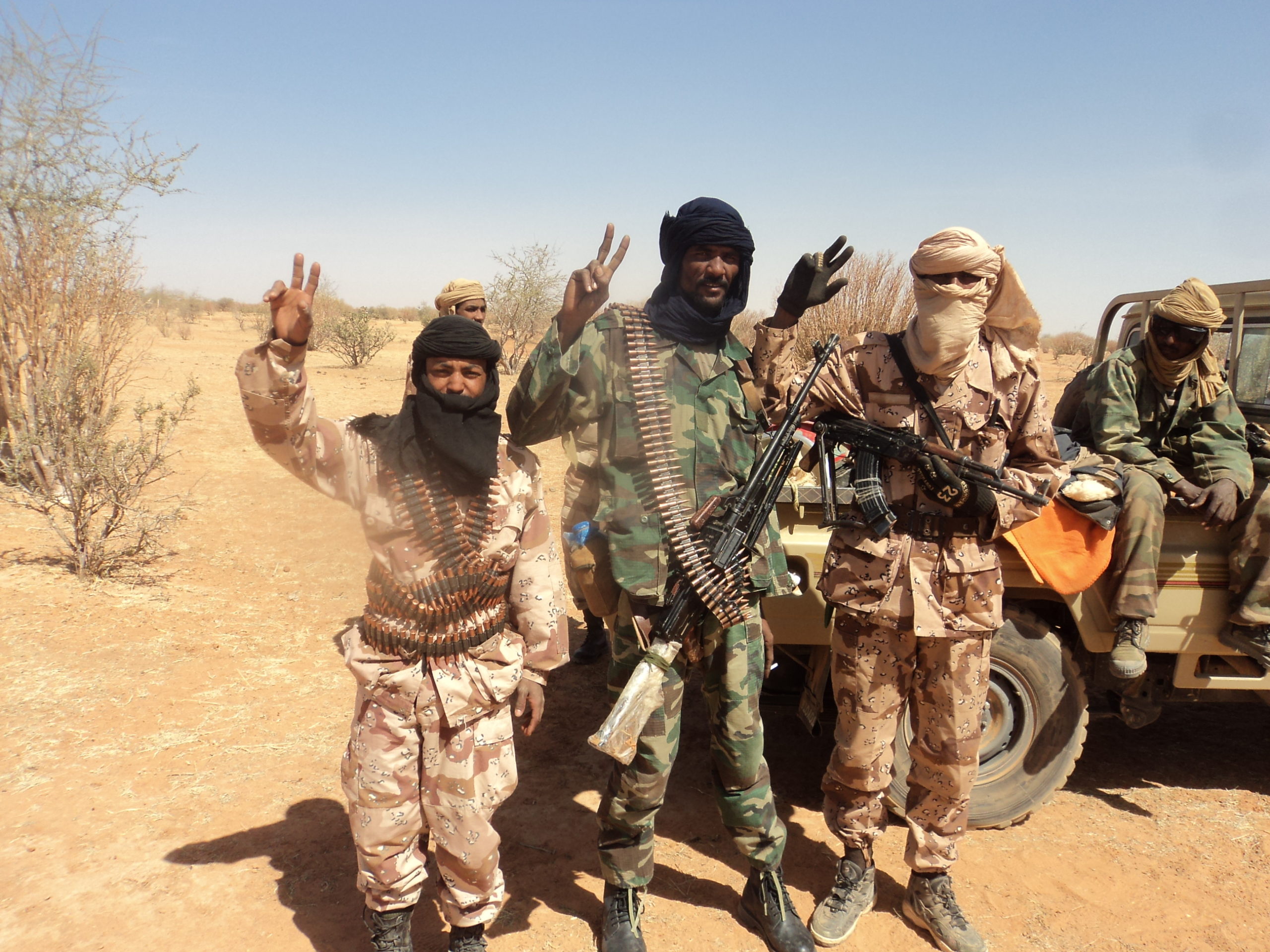Tuaregopprørere poserer for kamera i et ørkenområde.